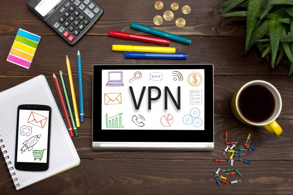 vpn services laptop coffee mug mobile phone agenda pencils desk 